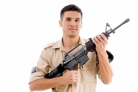 smiling soldier posing with gun with white background Stock Photo - Budget Royalty-Free & Subscription, Code: 400-05084990