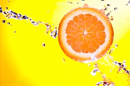 simsearch:400-04398564,k - View of piece of orange getting splashed  on yellow  back Stockbilder - Microstock & Abonnement, Bildnummer: 400-05085261