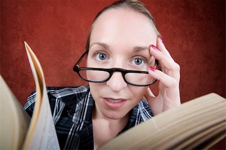 person reading a book confused - Perplexed woman with big eyes and glasses reading a book. Stock Photo - Budget Royalty-Free & Subscription, Code: 400-05085498