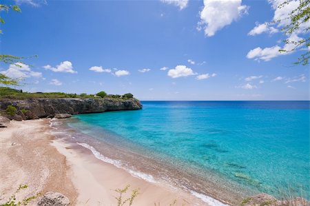 blue caribbean bay view  with a nice deserted beach Foto de stock - Super Valor sin royalties y Suscripción, Código: 400-05085806