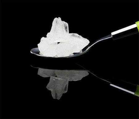 crystal sugar on a spoon over black reflective surface background Stock Photo - Budget Royalty-Free & Subscription, Code: 400-05086639