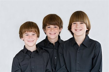 Portrait of Three Smiling Brothers Dressed in Black Stock Photo - Budget Royalty-Free & Subscription, Code: 400-05086706