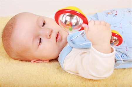 simsearch:400-04161658,k - Portrait of cute newborn playing with rattle Fotografie stock - Microstock e Abbonamento, Codice: 400-05087096