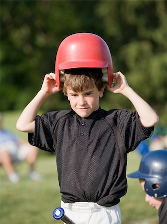 Little Boy Putting on Helmet Getting Ready to Hit Stock Photo - Budget Royalty-Free & Subscription, Code: 400-05087182