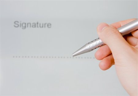simsearch:400-06454922,k - Hand holding a pen on a document ready to write or sign Stock Photo - Budget Royalty-Free & Subscription, Code: 400-05087312