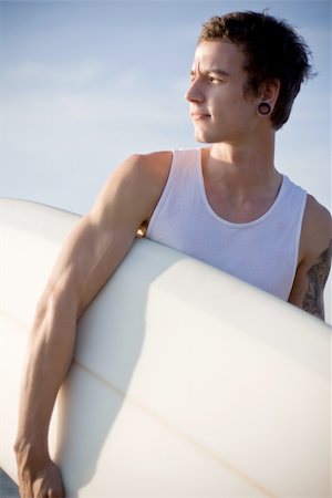 man at the beach holding his surfboard Foto de stock - Super Valor sin royalties y Suscripción, Código: 400-05088426