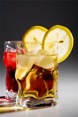 simsearch:400-03979160,k - Beautiful glasses with a cocktail, a lemon and an ice Stock Photo - Budget Royalty-Free & Subscription, Code: 400-05088535