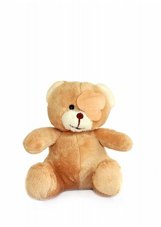 Teddy bear with plasters on its eye, over white. Stock Photo - Budget Royalty-Free & Subscription, Code: 400-05088797