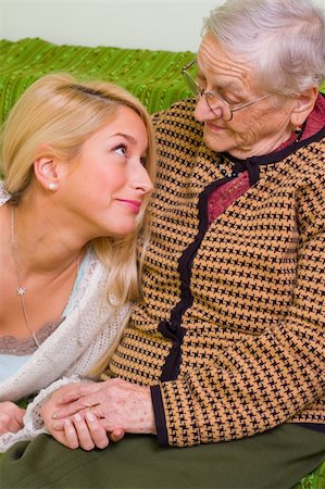 daughter helping elderly parent - A young woman  together whit an older one talking, smiling at her - part of a series. Stock Photo - Budget Royalty-Free & Subscription, Code: 400-05089379
