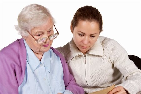 Old mother and her adult daughter sitting together and looking at very old photo Stock Photo - Budget Royalty-Free & Subscription, Code: 400-05089564