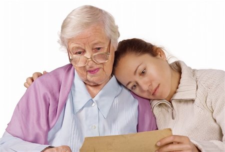 Loving mother and daughter sitting together and looking at very old photo Photographie de stock - Aubaine LD & Abonnement, Code: 400-05089563