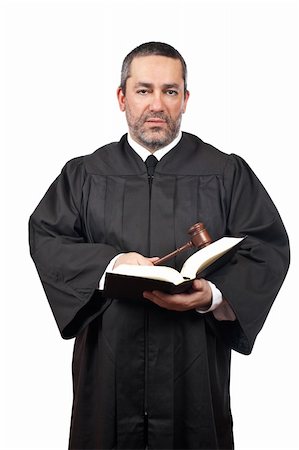 Serious male judge holding the gavel and reading a book, isolated on white background over a white background Stock Photo - Budget Royalty-Free & Subscription, Code: 400-05089816