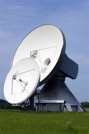 Two satellite dishes with blue sky and green grass. Stock Photo - Budget Royalty-Free & Subscription, Code: 400-05080009