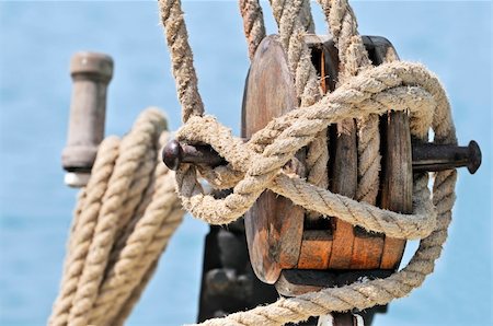 sailboat pulley - Close-up of a wooden block, winch and  rigging of an old sailboat Stock Photo - Budget Royalty-Free & Subscription, Code: 400-05080408