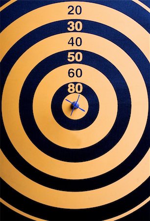 A magnetic dart board with dart(s) at the center (bullseye) Stock Photo - Budget Royalty-Free & Subscription, Code: 400-05080573