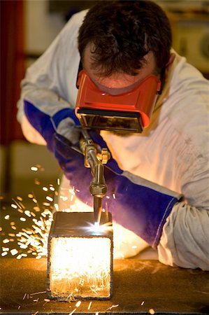 Welder using an acetylene torch to cut through a metal box.  Focus on the torch.   All work depicted is accurate and in compliance with industry code and safety regulations. Stock Photo - Budget Royalty-Free & Subscription, Code: 400-05081271