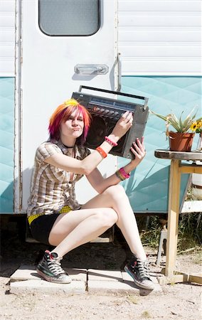 photo of people sit listening to radio - Punk girl with brightly colored hair sitting on trailer step holding boom box Stock Photo - Budget Royalty-Free & Subscription, Code: 400-05081637