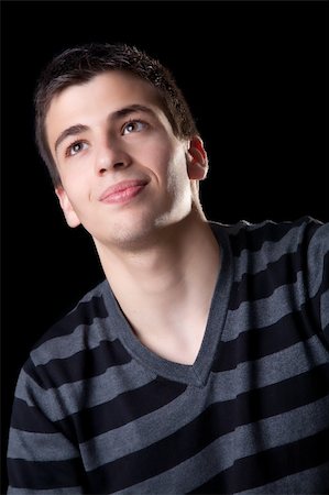 simsearch:400-04643781,k - Portrait of a handsome young man smiling. Isolated on black background. Stock Photo - Budget Royalty-Free & Subscription, Code: 400-05082043