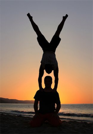 Two men silhouettes at sunset on the beach Stock Photo - Budget Royalty-Free & Subscription, Code: 400-05082916