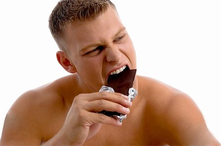physical fit food - muscular guy eating chocolate with white background Stock Photo - Budget Royalty-Free & Subscription, Code: 400-05082996