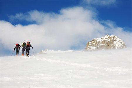 A group of backcountry skiers walks up to the top of the mountain in the blizzard, italian alps, europe. Stock Photo - Budget Royalty-Free & Subscription, Code: 400-05083109