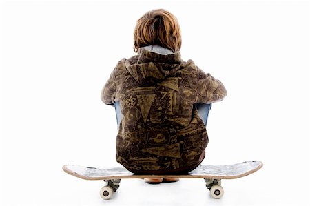back pose of boy sitting on skateboard with white background Stock Photo - Budget Royalty-Free & Subscription, Code: 400-05083187
