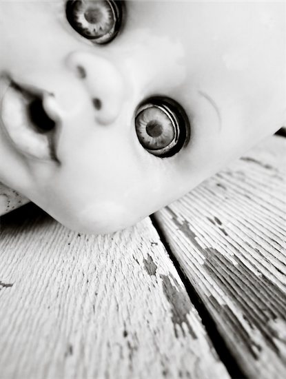 An old discarded childs's doll lying on the ground Stock Photo - Royalty-Free, Artist: stephconnell, Image code: 400-05083467