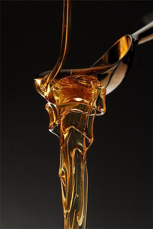Honey melting over the spoon isolated on black stock photo Photographie de stock - Aubaine LD & Abonnement, Code: 400-05083715