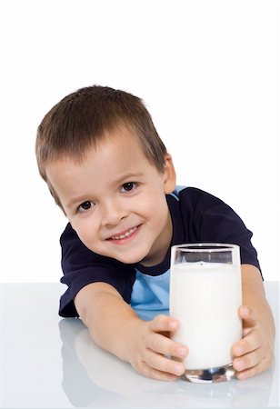 simsearch:400-04218582,k - Happy kid with a glass of milk leaning on the table - isolated Photographie de stock - Aubaine LD & Abonnement, Code: 400-05083794