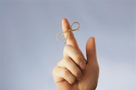 finger knot reminder - A string tied around an index finger Stock Photo - Budget Royalty-Free & Subscription, Code: 400-05094096