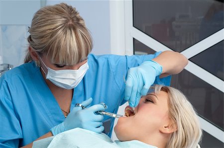 starush (artist) - female dentist at work, anaesthesia injection before cavity stopping Stockbilder - Microstock & Abonnement, Bildnummer: 400-05094306
