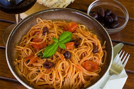 simsearch:400-06461717,k - A plate of spaghetti with italian sauce, served with red wine, bread and olives on a wooden table Stock Photo - Budget Royalty-Free & Subscription, Code: 400-05094364