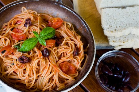 simsearch:400-06461717,k - A plate of spaghetti with italian sauce, served with red wine, bread and olives on a wooden table Stock Photo - Budget Royalty-Free & Subscription, Code: 400-05094366
