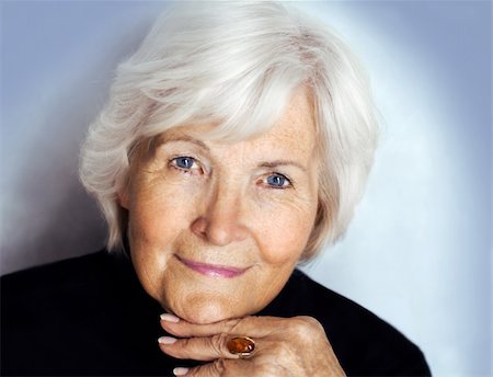 Senior lady portrait with black pullover on blue background Fotografie stock - Microstock e Abbonamento, Codice: 400-05094506