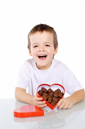 simsearch:400-05701644,k - Happy boy with chocolate in red heart shaped box - isolated Stock Photo - Budget Royalty-Free & Subscription, Code: 400-05095015