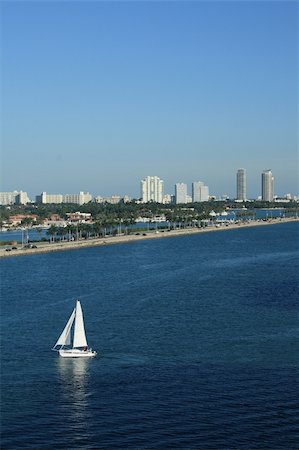 florida city beaches - Shot of South Beach, Miami, Florida.  Sailboats, palm trees, and office building all populate the scene. Stock Photo - Budget Royalty-Free & Subscription, Code: 400-05096194