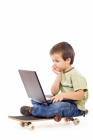 daycare on floor - Kid on a skateboard with a laptop - isolated mobile computing concept Stock Photo - Budget Royalty-Free & Subscription, Code: 400-05097211