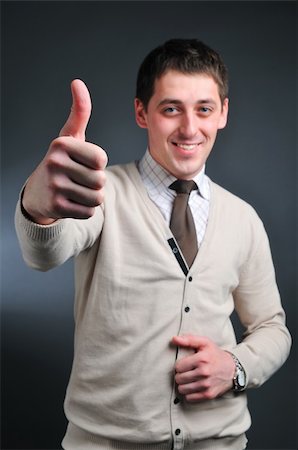 simsearch:400-05714996,k - Young man going thumb up, focused on arm Foto de stock - Super Valor sin royalties y Suscripción, Código: 400-05097927