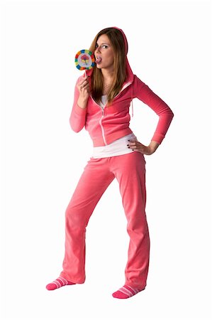 Young beautiful woman in the pink sportswear sitting with lollipop over white background Stock Photo - Budget Royalty-Free & Subscription, Code: 400-05097956