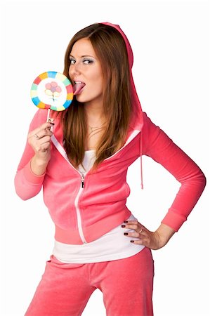 Young beautiful woman in the pink sportswear sitting with lollipop over white background Stock Photo - Budget Royalty-Free & Subscription, Code: 400-05097957