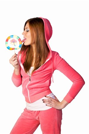 Young beautiful woman in the pink sportswear sitting with lollipop over white background Stock Photo - Budget Royalty-Free & Subscription, Code: 400-05097958