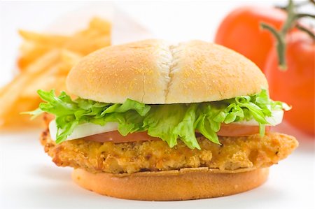 simsearch:400-04337832,k - crisp chicken burger with tomato onion cheese lettuce isolated Photographie de stock - Aubaine LD & Abonnement, Code: 400-05098129
