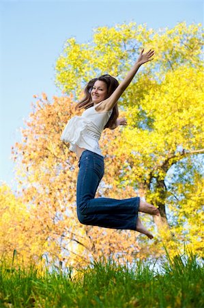 sergius (artist) - Happy beautiful girl jumping of joy on a fall day Foto de stock - Super Valor sin royalties y Suscripción, Código: 400-05098305