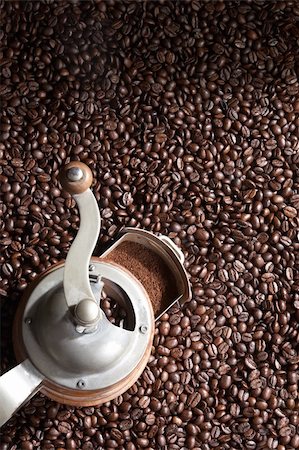 Brown coffee beans with coffee grinder covers the whole picture Stock Photo - Budget Royalty-Free & Subscription, Code: 400-05098497