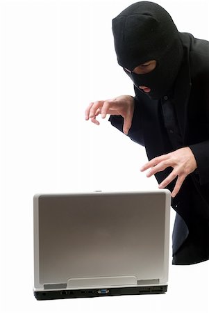 sneaky businessman laptop - A hacker about to break into a portable computer, isolated against a white background Stock Photo - Budget Royalty-Free & Subscription, Code: 400-05098720