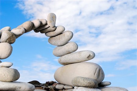 simsearch:400-05138433,k - Pile of sea stones in the form of the bridge and the blue sky Stock Photo - Budget Royalty-Free & Subscription, Code: 400-05090649