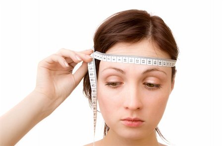 Young woman - measuring brain size (isolated on white) Stock Photo - Budget Royalty-Free & Subscription, Code: 400-05091110