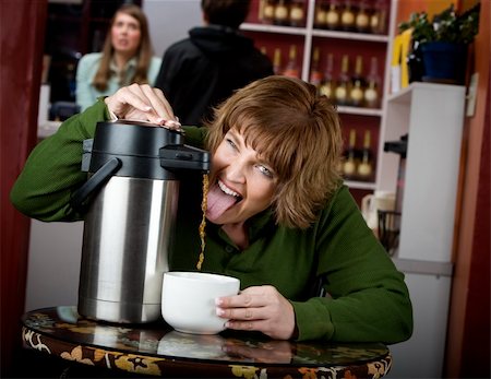 simsearch:400-04554624,k - Woman drinking coffee directly from a beverage dispenser Stock Photo - Budget Royalty-Free & Subscription, Code: 400-05091133