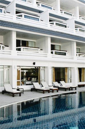 simsearch:400-03961189,k - Swimming pool with deck chairs at a tropical resort. Fotografie stock - Microstock e Abbonamento, Codice: 400-05091642