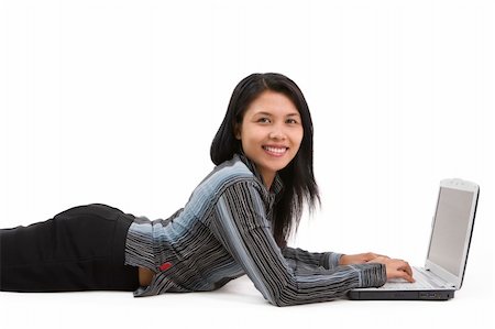 A beauty woman faing the camera while lie down on floor and typing on a laptop. Stock Photo - Budget Royalty-Free & Subscription, Code: 400-05091907